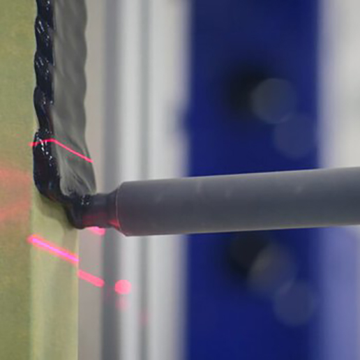 Closeup of PAR systems adhesive dispensing system dispensing adhesive.