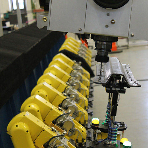 Robotic fixture holding carbon fiber part for drilling